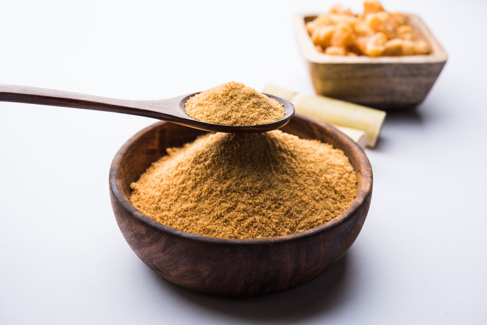 Organic Gur or Jaggery Powder is unrefined sugar obtained from concentrated sugarcane juice. served in a bowl. selective focus